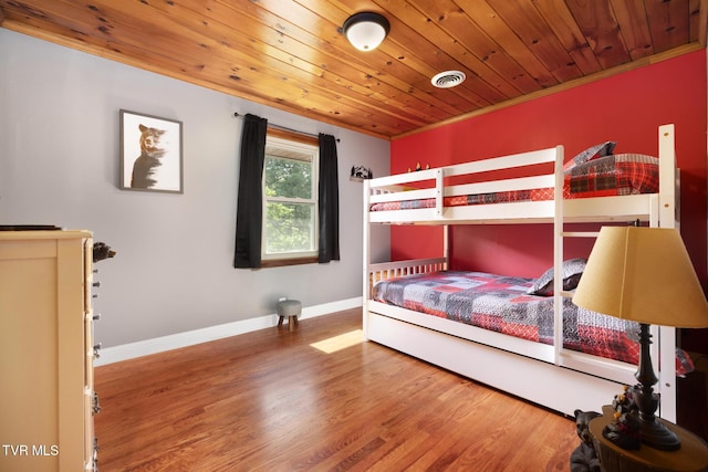 bedroom with wood-type flooring, crown molding, and wood ceiling