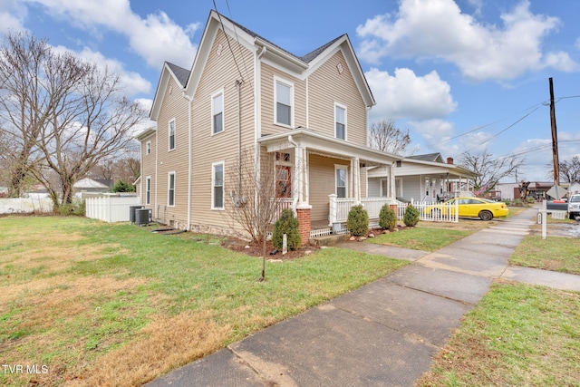 view of front facade with a front lawn, central AC unit, and a porch