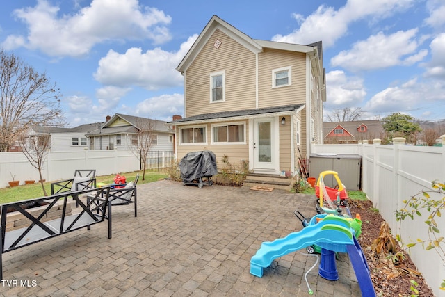 rear view of property featuring a patio area