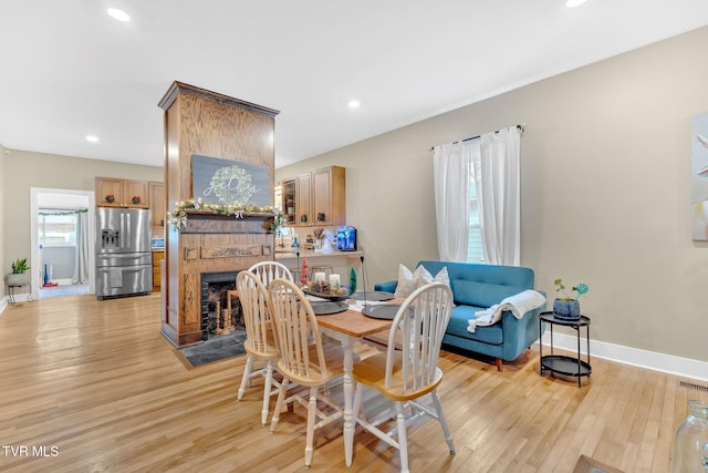 dining space with light hardwood / wood-style flooring