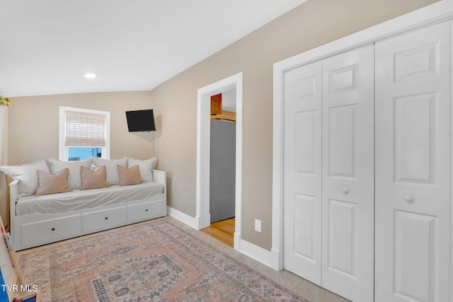 bedroom featuring a closet and lofted ceiling