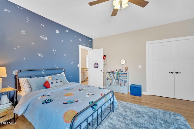 bedroom featuring a closet, ceiling fan, and light hardwood / wood-style flooring