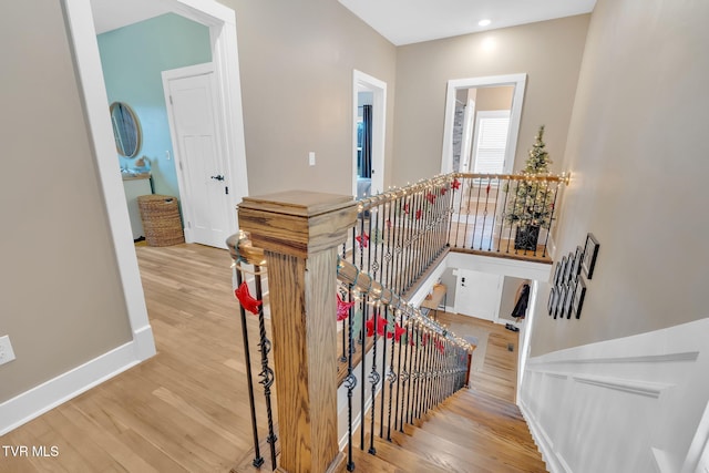 stairway with hardwood / wood-style flooring