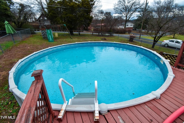 view of pool featuring a playground