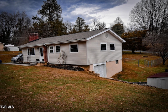 view of front of house with a front lawn and a garage