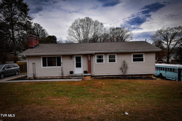 single story home with a front lawn