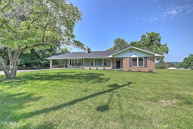 ranch-style home featuring a front yard and a carport