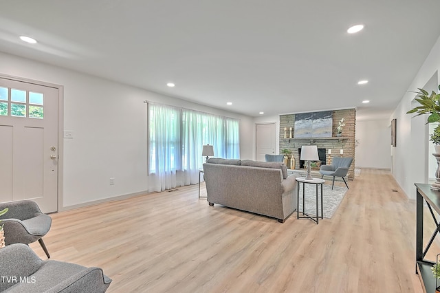 living room with a fireplace and light hardwood / wood-style floors