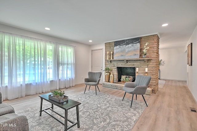 living room with hardwood / wood-style flooring and a fireplace