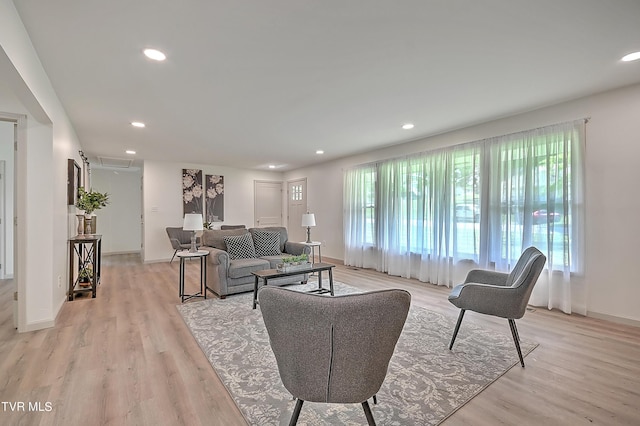 living room with a healthy amount of sunlight and light hardwood / wood-style flooring