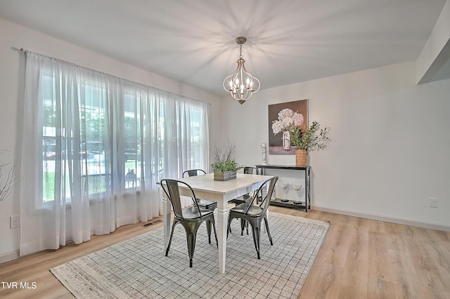 dining room with a notable chandelier and light hardwood / wood-style floors