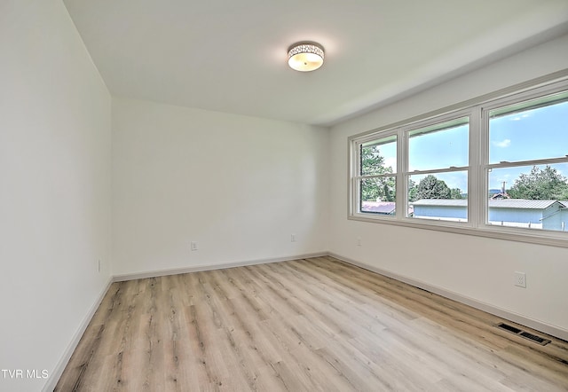 spare room with light hardwood / wood-style flooring