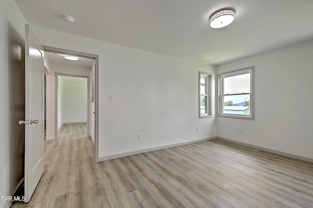 unfurnished room with light wood-type flooring