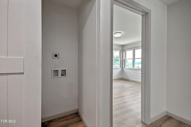 clothes washing area featuring hookup for a washing machine, light hardwood / wood-style flooring, and hookup for an electric dryer