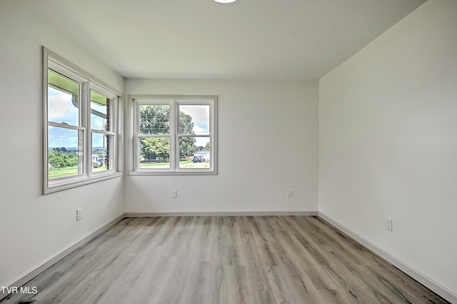 spare room featuring light hardwood / wood-style flooring