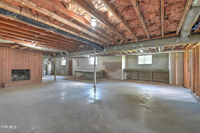 basement featuring a fireplace and electric water heater