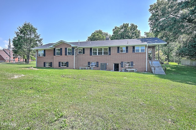 view of front of property featuring central AC and a front lawn