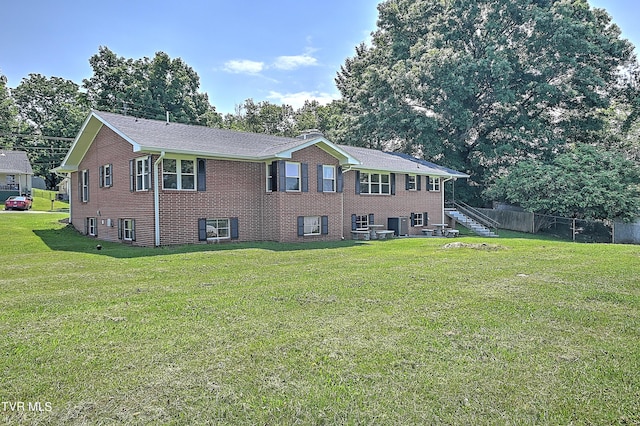 view of front of house with a front lawn and central air condition unit