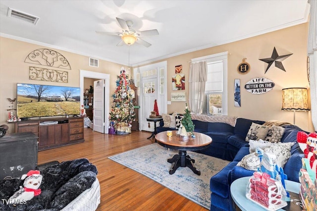 living room featuring crown molding, ceiling fan, and hardwood / wood-style flooring