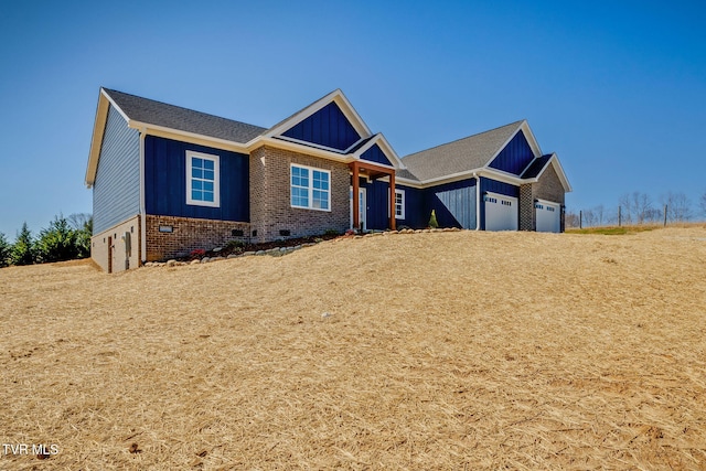 craftsman-style home featuring board and batten siding, crawl space, brick siding, and a garage