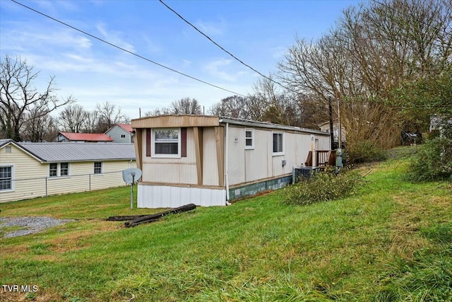 view of side of home with a yard