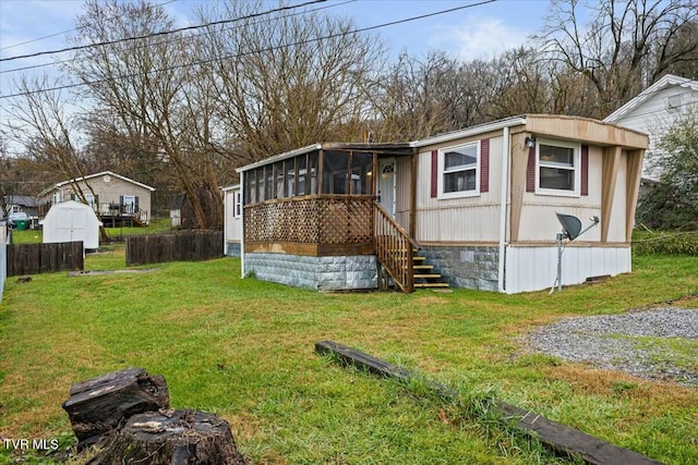 view of outdoor structure featuring a sunroom and a yard