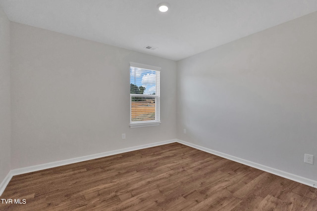 empty room with wood-type flooring