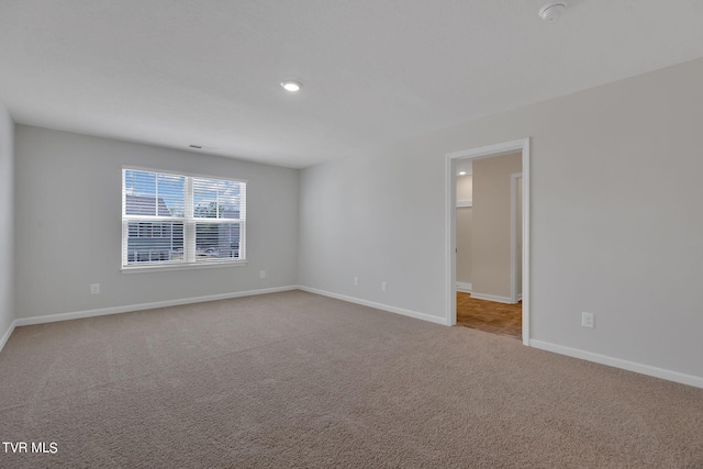 unfurnished room with light colored carpet