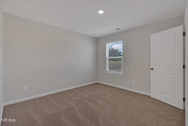 spare room with light carpet