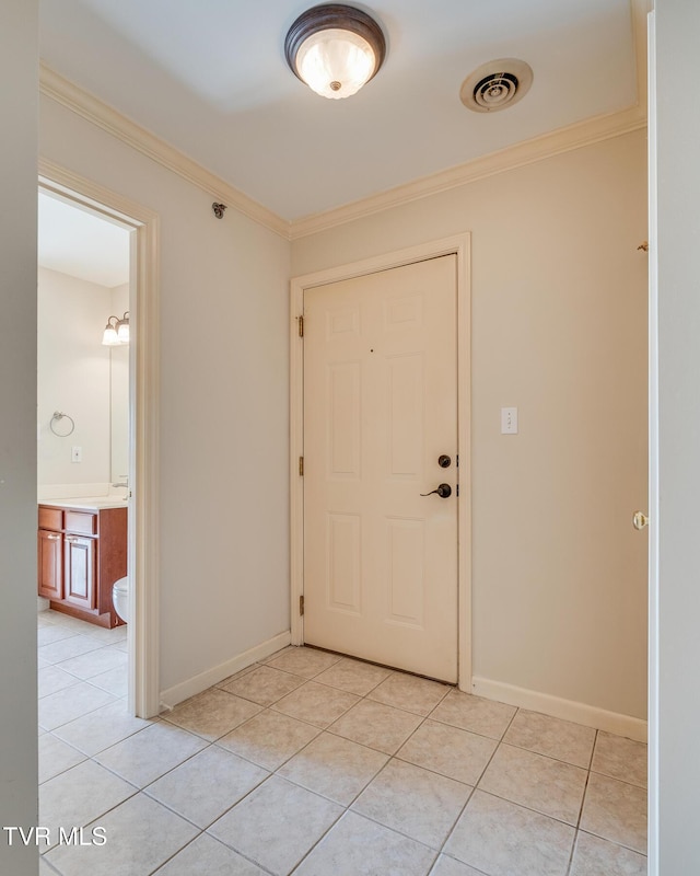 tiled foyer entrance with ornamental molding