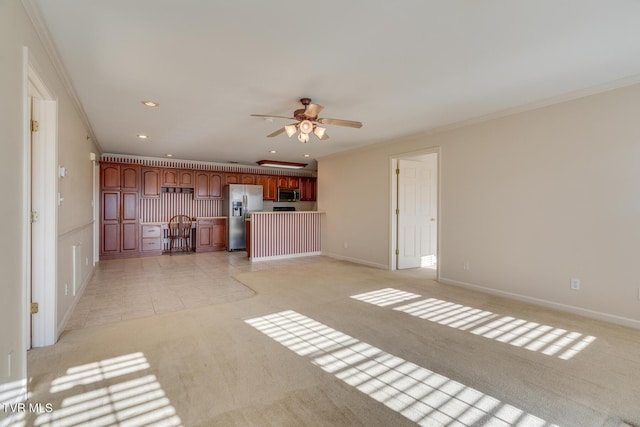 unfurnished living room featuring ceiling fan, light colored carpet, and ornamental molding