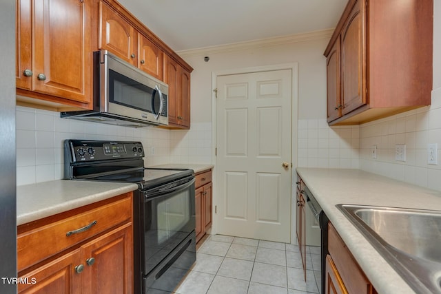 kitchen with backsplash, sink, ornamental molding, light tile patterned flooring, and stainless steel appliances