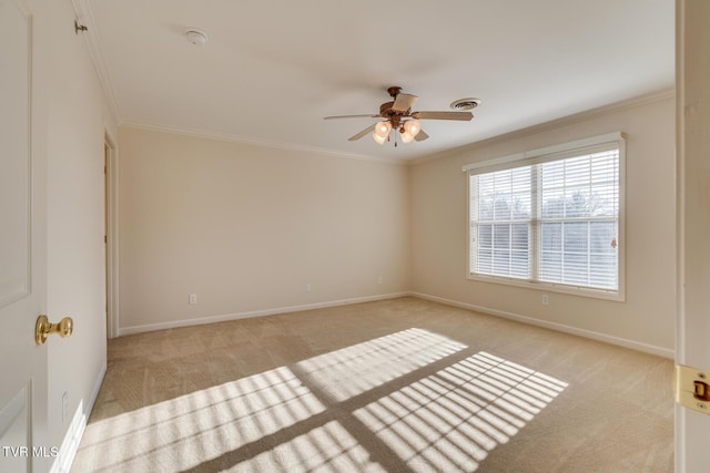 carpeted empty room with ceiling fan and crown molding