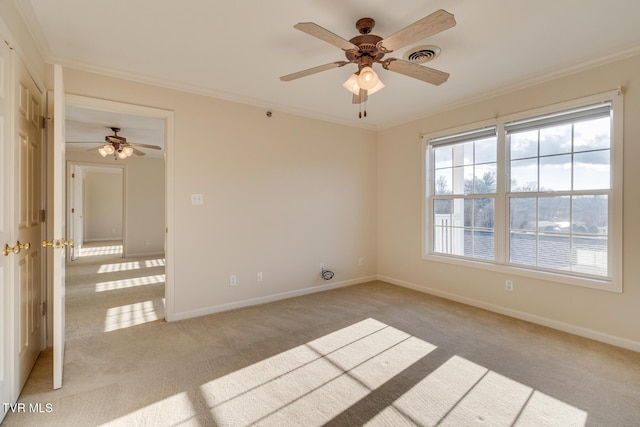 carpeted empty room with ceiling fan and ornamental molding