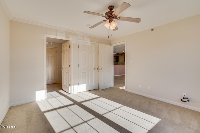 unfurnished bedroom with light carpet, a closet, ceiling fan, and ornamental molding