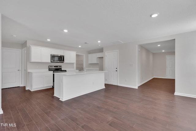 kitchen featuring stainless steel appliances, recessed lighting, white cabinetry, and dark wood-style floors