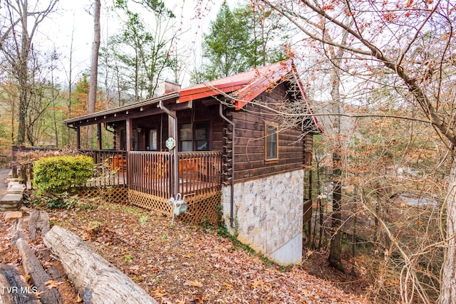 view of property exterior with a wooden deck