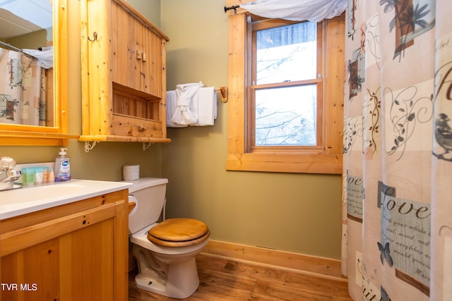 bathroom featuring hardwood / wood-style floors, vanity, and toilet