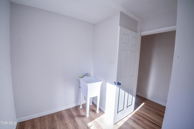 laundry area with light wood-type flooring