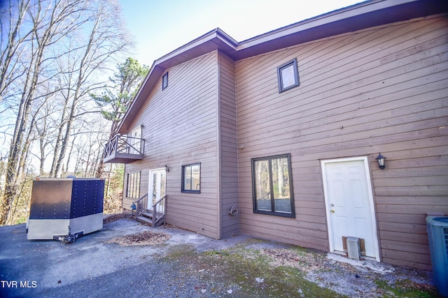 view of side of property with a balcony