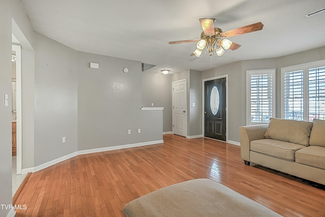 foyer with ceiling fan and light wood-type flooring