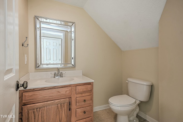 bathroom featuring vanity, tile patterned floors, vaulted ceiling, toilet, and a textured ceiling