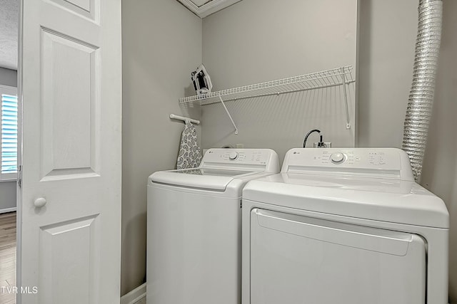 laundry area with separate washer and dryer