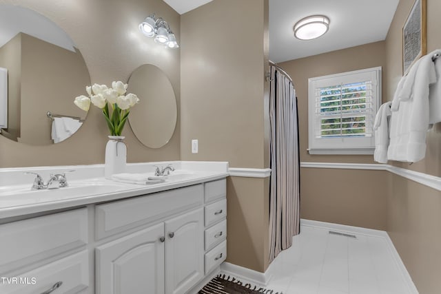 bathroom featuring vanity and curtained shower