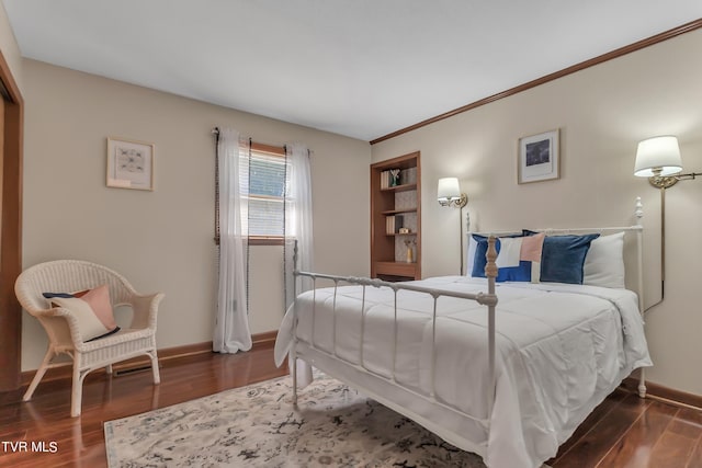 bedroom with dark hardwood / wood-style floors