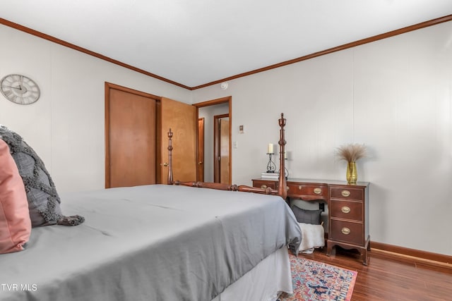 bedroom with dark hardwood / wood-style floors and ornamental molding