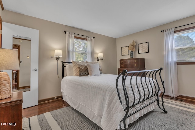 bedroom with hardwood / wood-style flooring