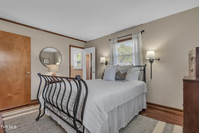 bedroom featuring dark hardwood / wood-style flooring and ornamental molding