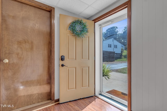 entryway with a paneled ceiling, a healthy amount of sunlight, and light hardwood / wood-style floors