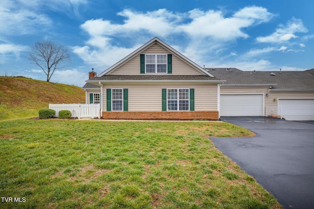 view of front of home featuring a garage and a front lawn